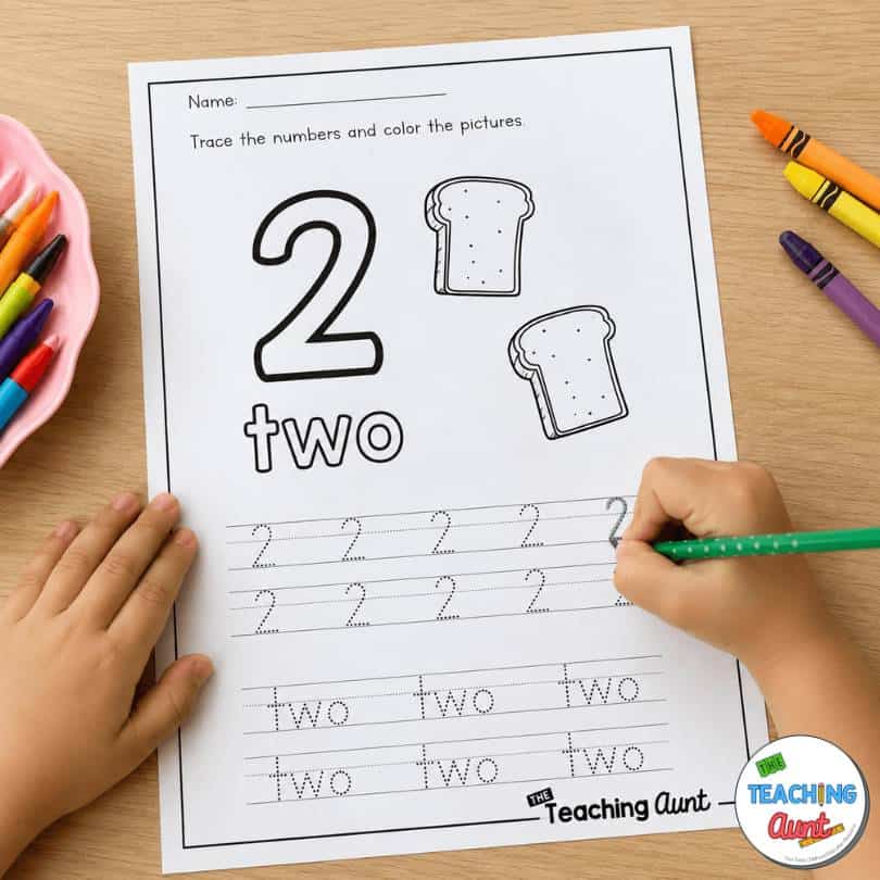 Child practicing number 2 with a number tracing worksheet for preschool